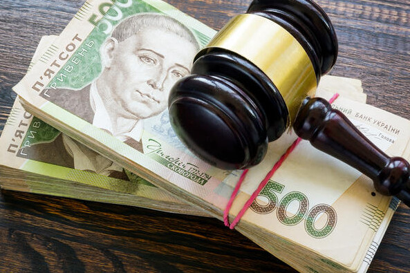 Ukrainian hryvnia money and a gavel. Bribery and corruption in court.